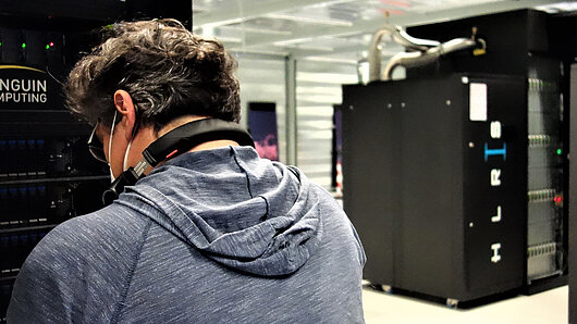 Photo of technician installing computing cluster