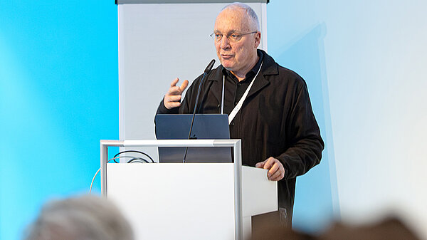 A man speaks at a podium.