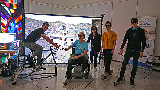 Photo of HLRS staff members in front of projection of Stuttgart city hall.