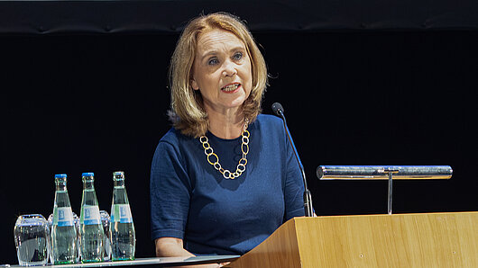 A woman speaks at a podium