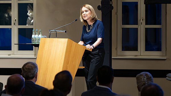 A woman speaks at a podium.