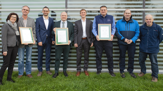 Photo of the HLRS sustainability team with certificates.