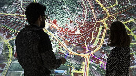 Picture of people looking at visualization of digital twin city 