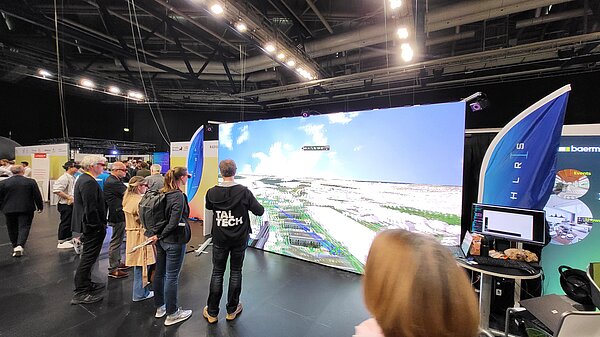 A member of HLRS is showing a visualization on the LED display wall