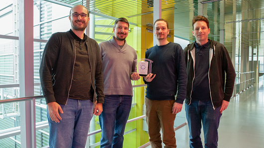 Team Members Hold Innovation Award Trophy