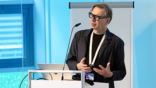 A man speaks at a podium.