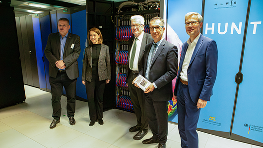 Group photo in front of the supercomputer Hunter