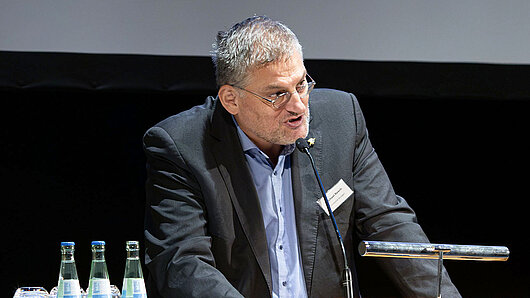 A man speaks at a podium
