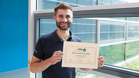 Joseph Schuchart holds a certificate.