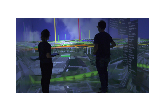 Two scientists observe a room-sized, projected visualization of the University of Stuttgart campus.
