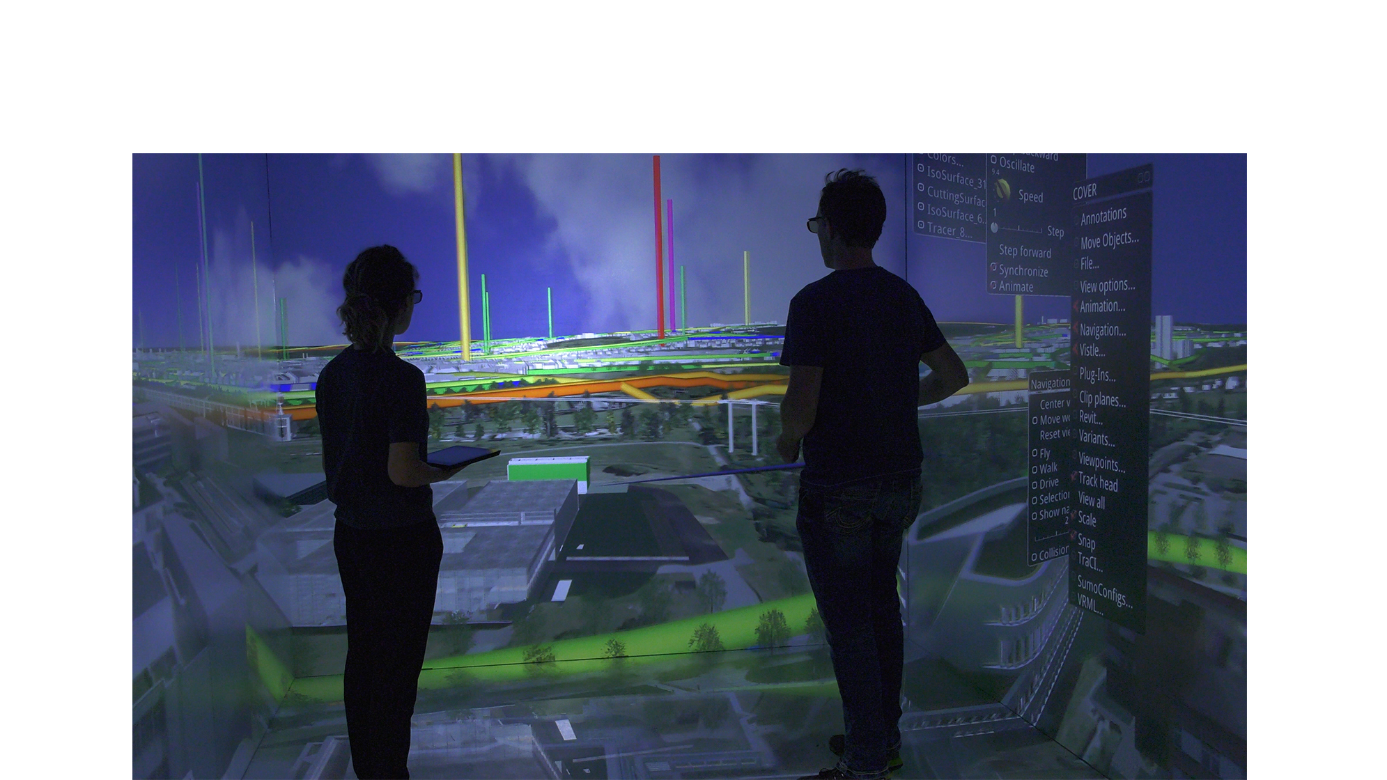 Two scientists observe a room-sized, projected visualization of the University of Stuttgart campus.