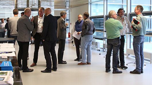 Participants in an HLRS workshop in conversation during a program break.