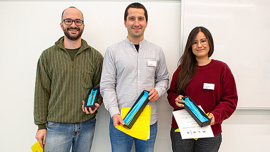 Group portrait of the three Golden Spike Award winners, holding their awards