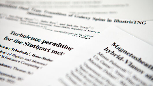 Photo of user research publication papers.