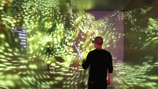 Photo of scientists observing 3D computer visualization