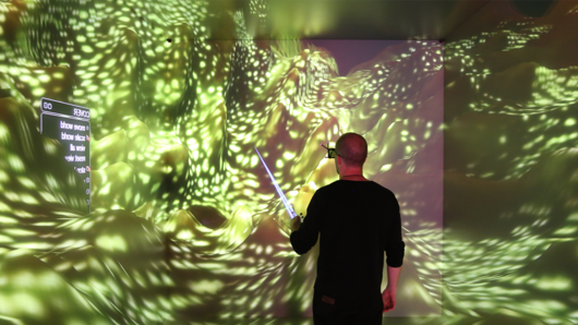 Photo of scientists observing 3D computer visualization