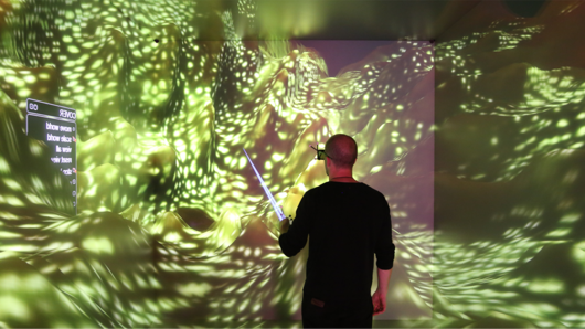 Photo of scientists observing 3D computer visualization