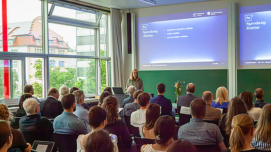 Photo of Kirstin Dickhaut at the podium during the Re2 kickoff symposium.