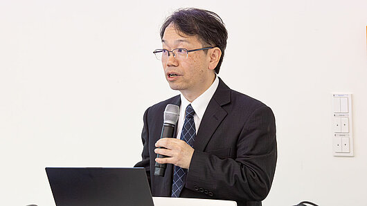 A man speaks at a podium.