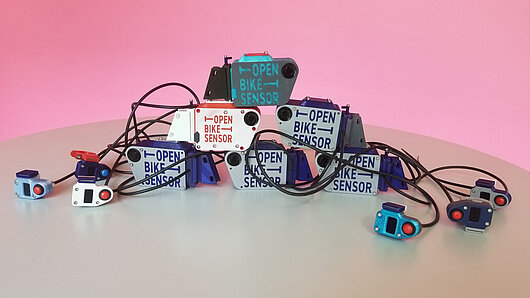 Photo showing collection of OpenBikeSensor sensors on a table.
