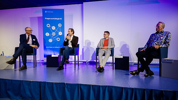 Foto der Redner während der Podiumsdiskussion.