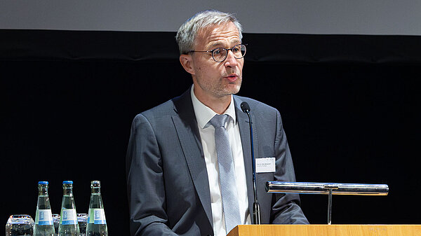 A man speaks at a podium