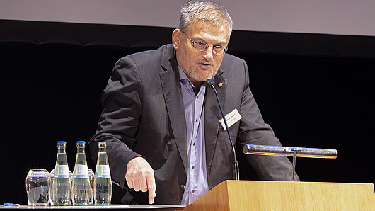 A man speaks at a podium