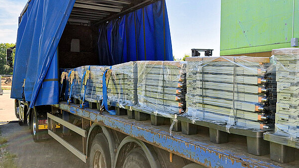 Pallets of computer hardware on a flatbed truck.